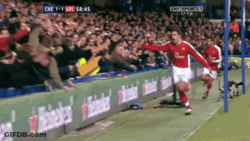 A Soccer Player Celebrates A Goal In Front Of A Crowd With Sky Sports Live In The Background GIF