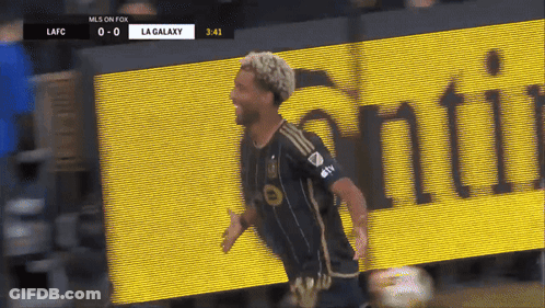 A Soccer Player Celebrates A Goal In Front Of A La Galaxy Banner GIF