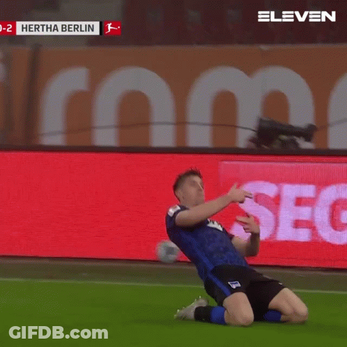 A Soccer Player Celebrates A Goal In Front Of A Screen That Says Hertha Berlin GIF