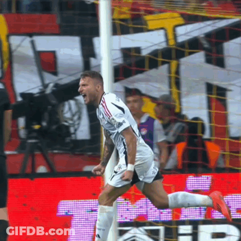 A Soccer Player Celebrates After Scoring A Goal In Front Of A Sign That Says ' Tb ' GIF