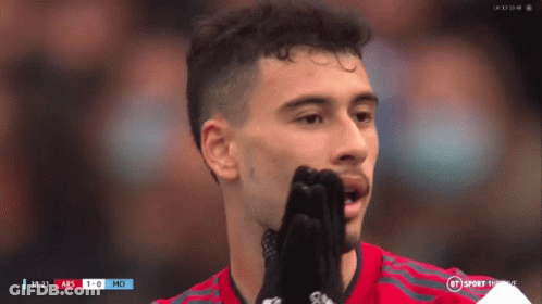 A Soccer Player Covering His Mouth With His Hands While Watching A Game GIF