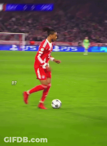 A Soccer Player Dribbles A Ball On A Field With A Ps5 Ad Behind Him GIF