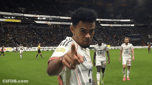 A Soccer Player Giving A Thumbs Up In Front Of A Sign That Says ' Deutsche ' GIF