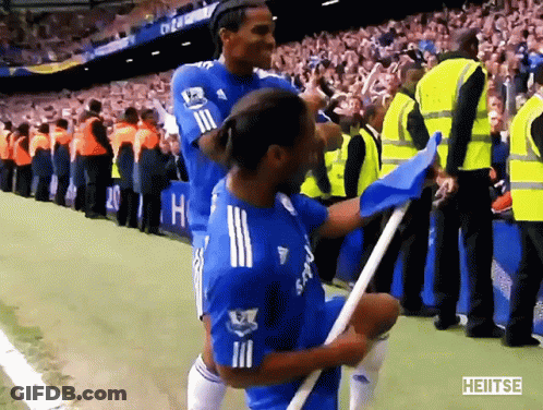 A Soccer Player Holding A Blue Flag With The Word Heitse On The Bottom Left GIF