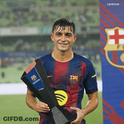 A Soccer Player Holding A Trophy In Front Of A Canirove Sign GIF