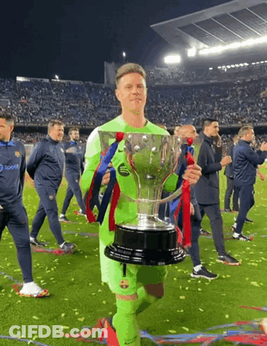 A Soccer Player Holding A Trophy With A Pepsi Logo On His Jersey GIF
