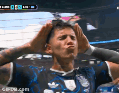 A Soccer Player Holds His Hands To His Head In Front Of A Scoreboard That Says Arg On It GIF