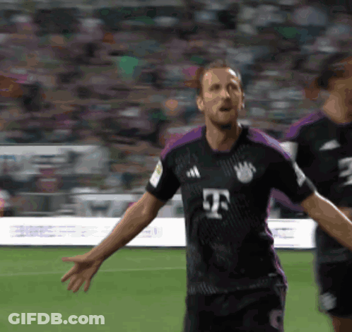 A Soccer Player In A Black And Purple Jersey With The Letter T On The Front GIF