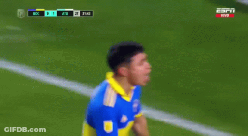 A Soccer Player In A Blue And Yellow Jersey Stands In Front Of A Goal During A Game GIF