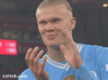 A Soccer Player In A Blue Jersey Is Clapping His Hands . GIF