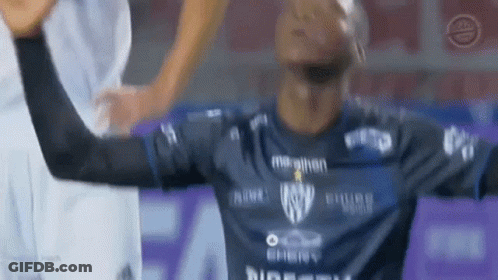 A Soccer Player In A Blue Shirt Is Raising His Arms In The Air GIF