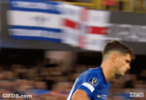 A Soccer Player In A Blue Shirt Is Running On A Field . GIF