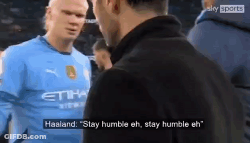 A Soccer Player In A Blue Shirt Is Talking To Another Man In A Black Jacket . GIF