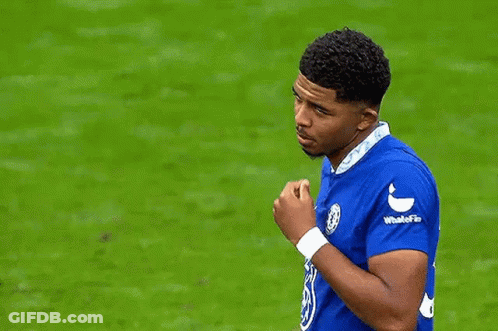 A Soccer Player In A Blue Shirt Is Talking To Another Player On The Field . GIF