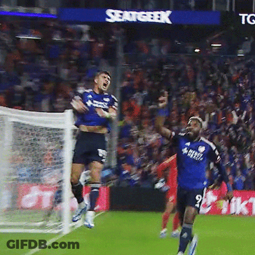 A Soccer Player In A Blue Shirt With The Number 9 On It Jumps In The Air GIF