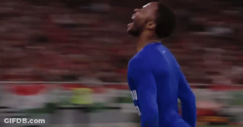 A Soccer Player In A Blue Suit Is Running On A Field GIF