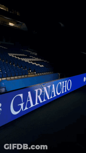 A Soccer Player In A Blue Uniform Is Standing In Front Of A Sign That Says Riya GIF