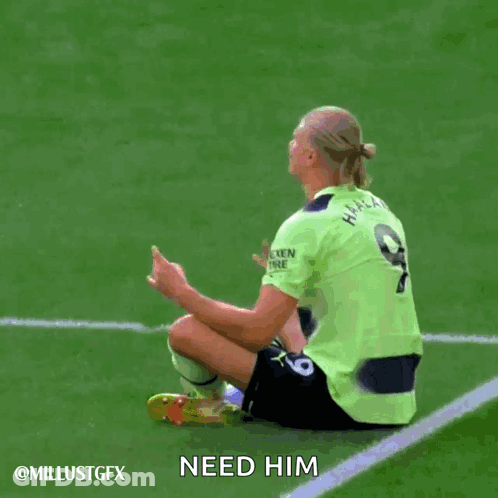 A Soccer Player In A Green Etihad Airways Jersey Is Sitting On The Field GIF