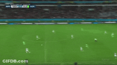 A Soccer Player In A Green Jersey Kicks A Soccer Ball GIF