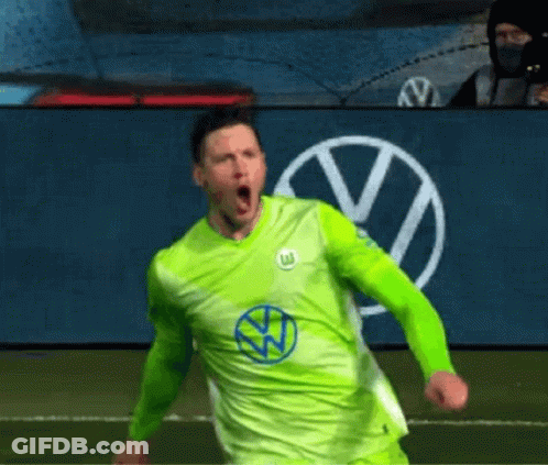 A Soccer Player In A Green Shirt Is Celebrating A Goal On A Field . GIF