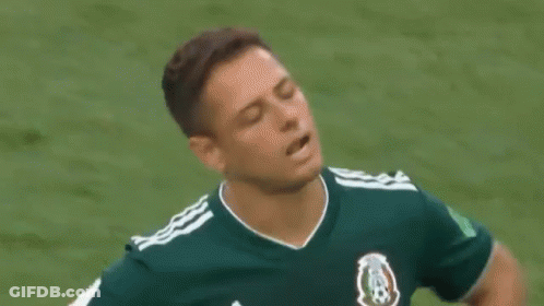A Soccer Player In A Green Shirt Is Standing On A Field . GIF
