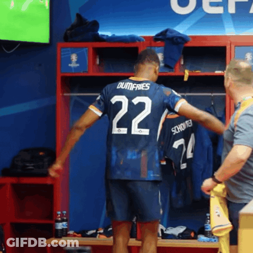 A Soccer Player In A Locker Room With The Number 22 On His Jersey GIF