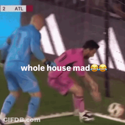 A Soccer Player In A Pink Shirt Is Being Tackled By A Goalie GIF