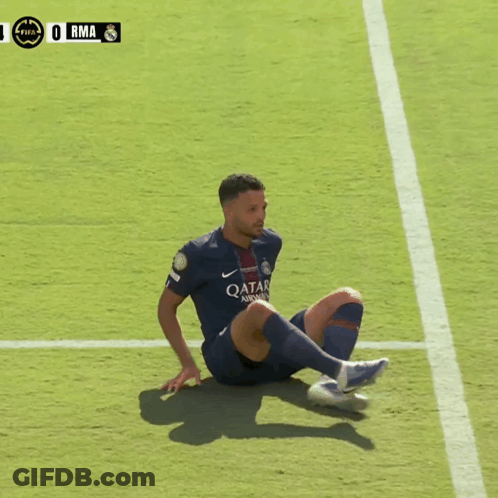 A Soccer Player In A Qatar Shirt Sits On The Field GIF