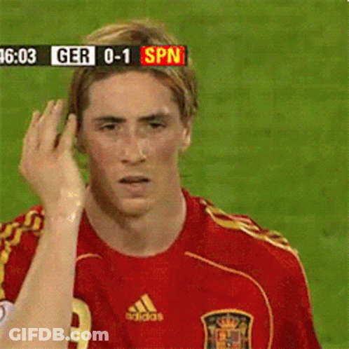 A Soccer Player In A Red Adidas Jersey Looks At The Camera GIF
