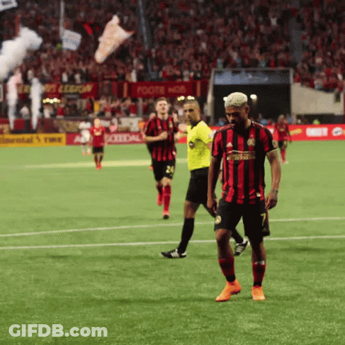 A Soccer Player In A Red And Black Jersey With The Number 7 On It GIF