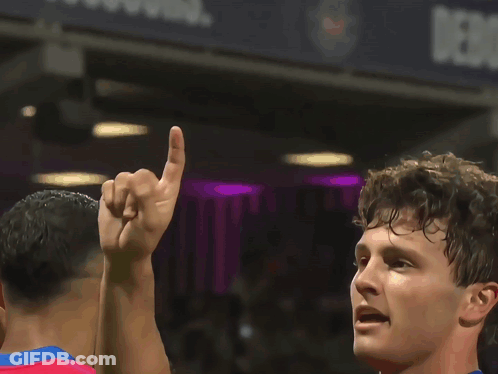 A Soccer Player In A Red And Blue Jersey With Akw On His Back GIF