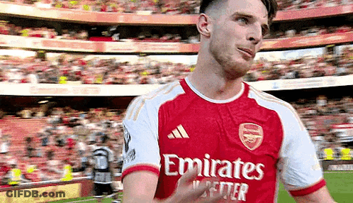 A Soccer Player In A Red And White Emirates Jersey Is Giving A Thumbs Up . GIF