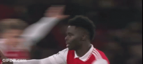 A Soccer Player In A Red And White Jersey Is Giving A Thumbs Up During A Soccer Game . GIF