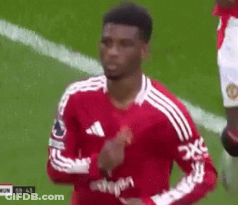 A Soccer Player In A Red And White Jersey Is Running On A Soccer Field . GIF