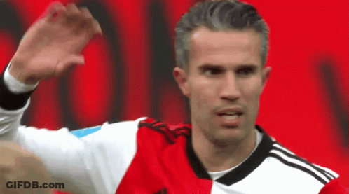 A Soccer Player In A Red And White Jersey Is Waving His Hand GIF
