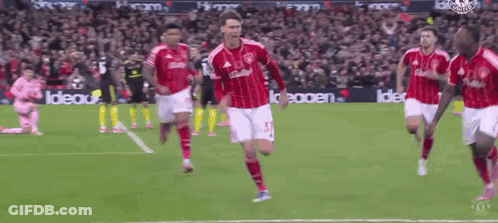 A Soccer Player In A Red And White Jersey With The Number 15 On It GIF
