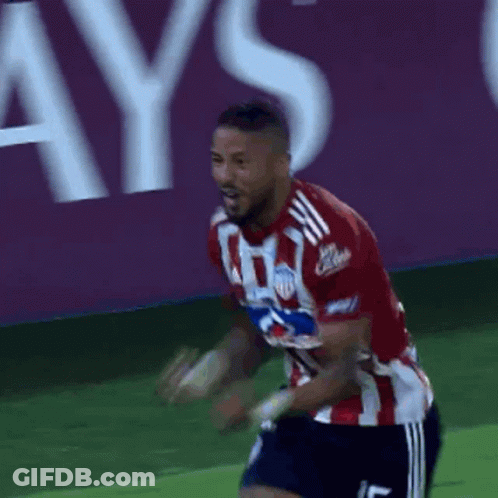 A Soccer Player In A Red And White Jersey With The Number 5 On His Shorts GIF