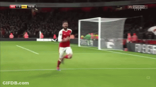 A Soccer Player In A Red Jersey Is Running Towards The Goal GIF