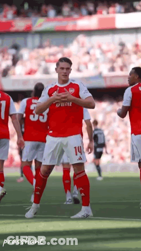 A Soccer Player In A Red Jersey With The Number 14 On His Shorts GIF