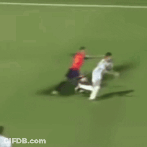 A Soccer Player In A Red Shirt Is Doing A Trick On A Soccer Field . GIF