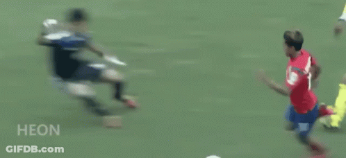 A Soccer Player In A Red Shirt Is Running On A Field . GIF