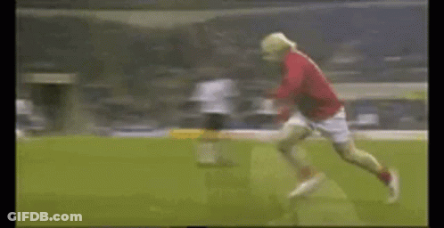 A Soccer Player In A Red Shirt Is Running On The Field GIF