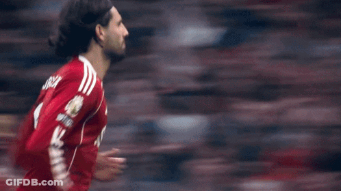 A Soccer Player In A Red Shirt Is Running Towards The Goal GIF