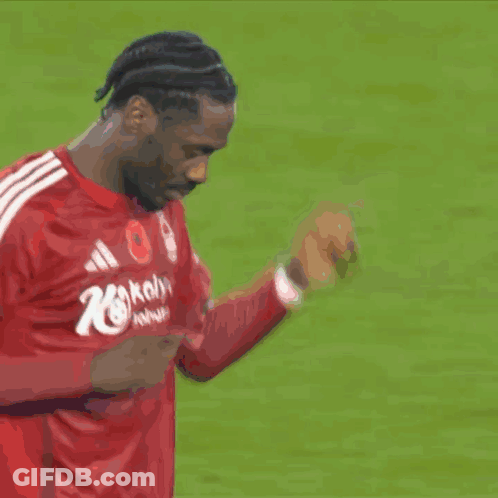 A Soccer Player In A Red Shirt With The Number 10 On It Shakes Hands With Another Player GIF