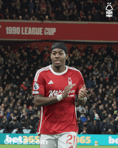 A Soccer Player In A Red Shirt With The Number 21 On His Shorts GIF