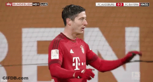 A Soccer Player In A Red T-Mobile Jersey Is Standing In Front Of A Large T-Mobile Sign . GIF