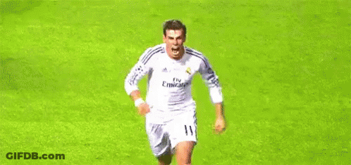 A Soccer Player In A White Jersey Is Running On A Soccer Field . GIF