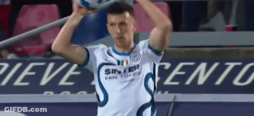 A Soccer Player In A White Shirt Is Holding A Soccer Ball In His Hands . GIF