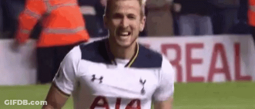 A Soccer Player In A White Shirt Is Smiling On The Field . GIF