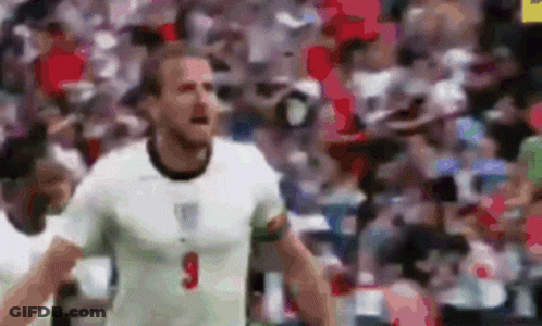 A Soccer Player In A White Shirt With The Number 9 On His Chest Is Standing In Front Of A Crowd . GIF